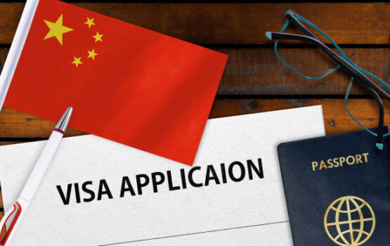 Flag of China , visa application form and passport on table